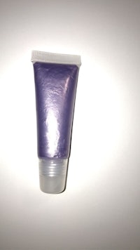 a tube of purple liquid eyeliner on a white surface