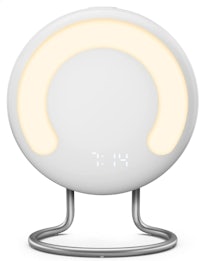 a white alarm clock on a stand